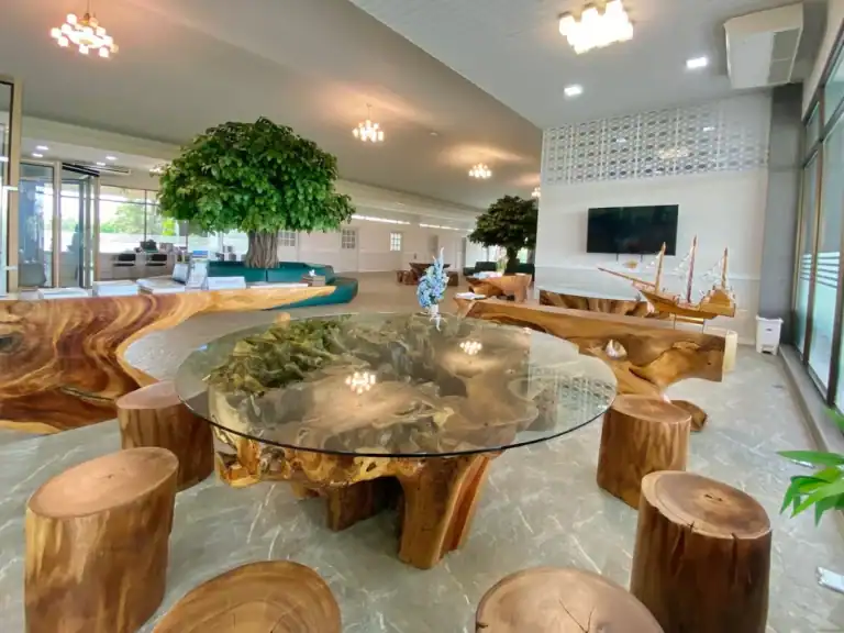 Modern hospital lobby with natural wood furniture and indoor plants, promoting health and wellness in Bangkok - Lobby Sanpudard Wellness Club