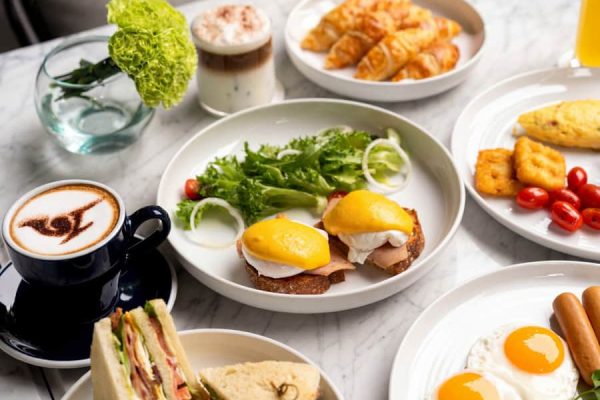 Breakfast spread with eggs, salad, pastries, fruit and coffee for wellness retreat guests
