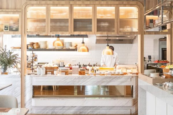 Bright open kitchen with a breakfast buffet and freshly prepared dishes