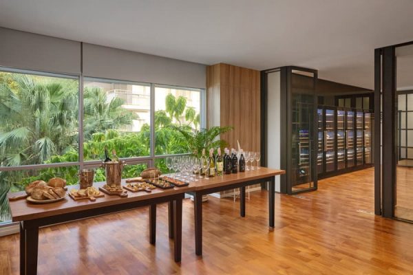 Refreshment and snack table prepared beside large windows with tropical views