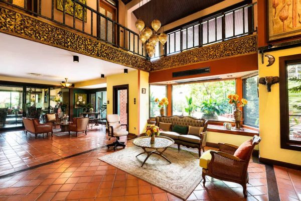 Bright sitting room with sofas, artwork and garden views for group reflection