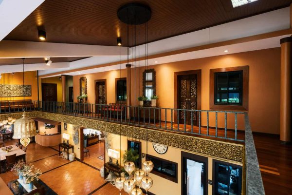Decorative hanging lanterns and carved balcony details above the retreat atrium