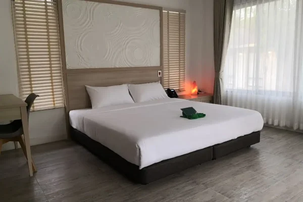 bedroom hotel room with modern decor in Bangkok, comfortable bed, natural light, and relaxing ambiance - Bedroom Sanpudard Wellness Club