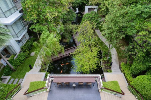 Aerial view of tropical garden paths, water features and low-rise accommodation buildings